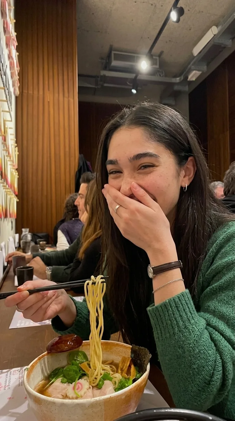 Kylie laughing over a bowl of ramen