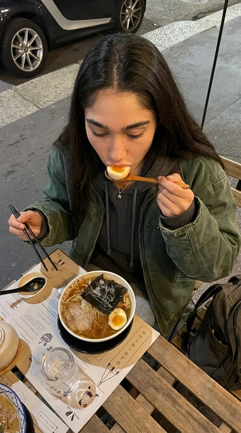 Kylie eating ramen at a counter